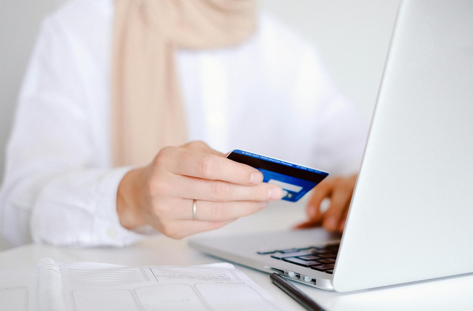 Elderly woman paying bill online with a credit card